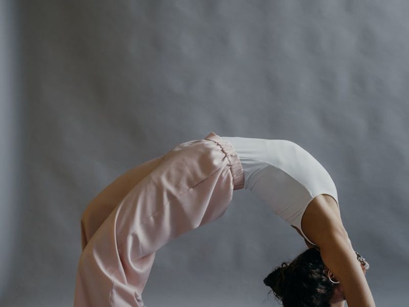 A person performing a gentle yoga stretch, highlighting increased flexibility.